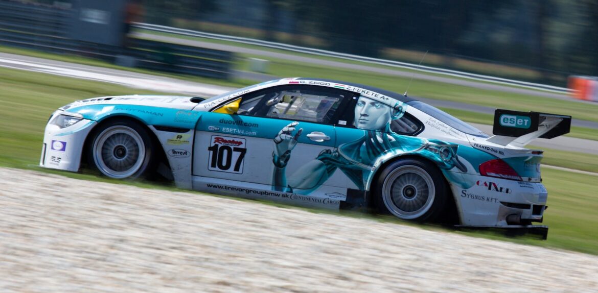 A racing car speeding around the track during a motorsport competition.